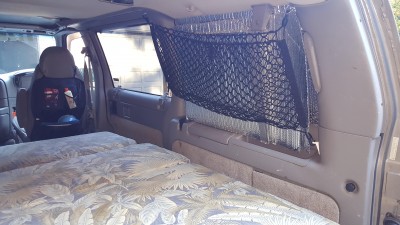 I left the oem r/r interior panel in, and still store the jack and tools in the oem location. I added the cargo netting 1) to hold the bubble wrap insulation panels cut to fit all the windows, works great by the way. and 2) to add more storage.